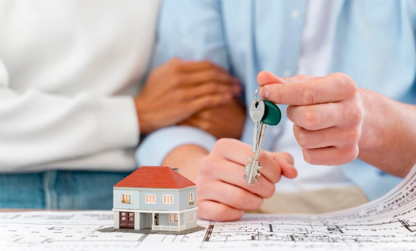 Couple holding keys about to rent